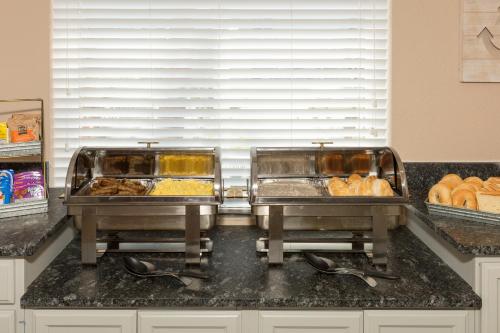 two trays of food on top of a kitchen counter at Amelia Hotel at the Beach in Fernandina Beach