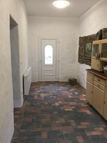 a room with a door and a tile floor at Gut Fischer in Pomssen
