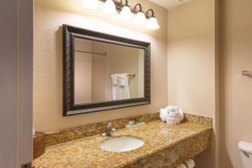 a bathroom with a sink and a mirror at Amelia Hotel at the Beach in Fernandina Beach