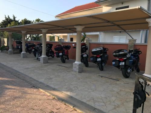 a group of motorcycles parked under a gazebo at Apartment Valerija in Privlaka