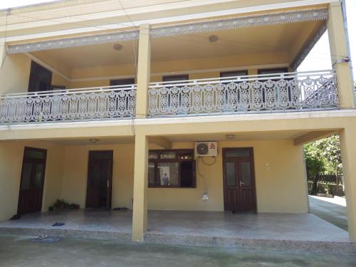 a house with a balcony on the second floor at Guest House on Angisa in Batumi