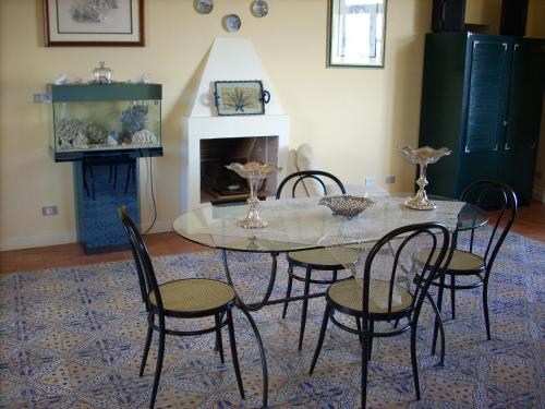 ミラッツォにあるDependance di Villa Elizabeth 4 posti lettoのダイニングルーム(ガラスのテーブル、椅子付)