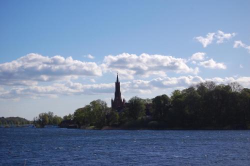 a church on an island in the middle of a lake at Auf dem Berg in Malchow