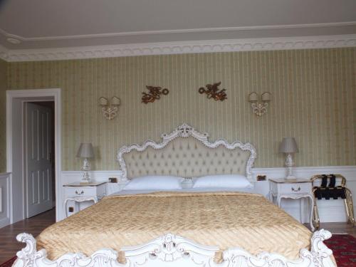 a bedroom with a white bed and two tables at Villa-Angelina in Langenzersdorf