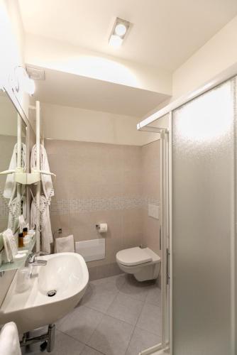 a bathroom with a sink and a toilet and a shower at Hotel Saviola in Sirmione