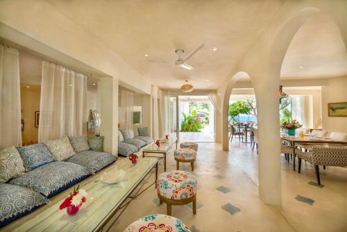a living room with a couch and a dining room at Casa Coco by Coco B Isla in Isla Mujeres