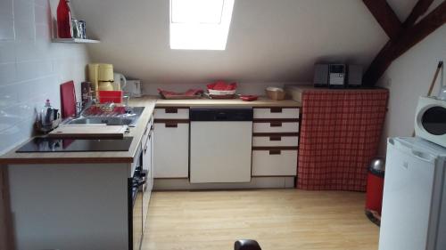 a small kitchen with a sink and a refrigerator at Gite En Alsace in Rouffach