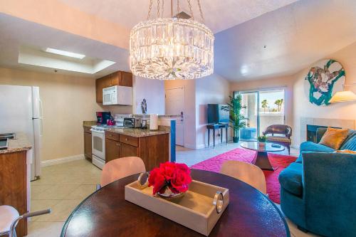 a kitchen and a living room with a table in a room at Luxury Modern Condo 2 in Las Vegas