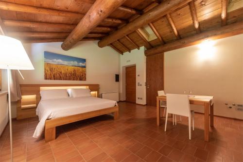 a bedroom with a bed and a desk and a table at Agriturismo Ca' Giulietta in Sommacampagna