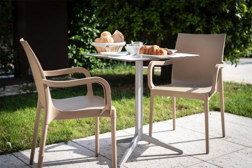 a table and two chairs with a plate of bread on it at Agriturismo Ca' Giulietta in Sommacampagna