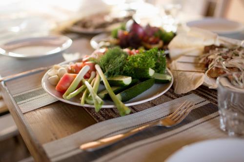 a table with a plate of food on a table at Hotel & Restaurant Complex HAP-OK in Brodki