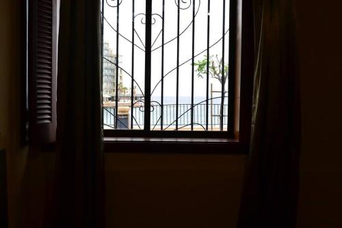an open window with a view of a balcony at Le Malte House St. Julians in St Julian's