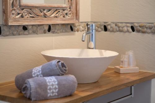 une salle de bain avec un lavabo et des serviettes sur un comptoir dans l'établissement Casa Eva Maria, à Patrimonio