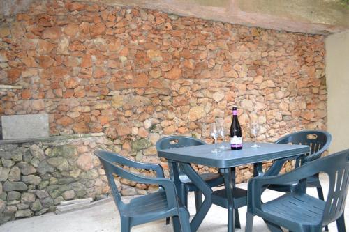 a table and chairs with a bottle of wine on it at Le Malte House St. Julians in St Julian's