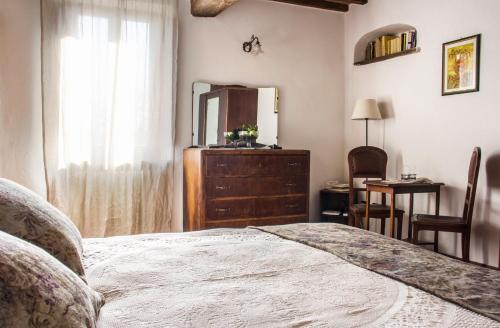 a bedroom with a bed and a dresser and a mirror at Casa Donella B&B in Gricignano