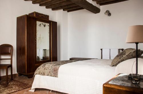 a bedroom with a bed and a dresser and a mirror at Casa Donella B&B in Gricignano