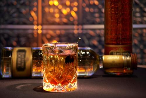 a glass of whiskey sitting on a table at Revere Hotel Boston Common in Boston