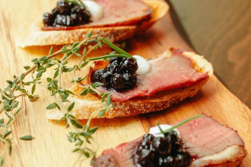 a wooden cutting board with two slices of bread with jam at Revere Hotel Boston Common in Boston