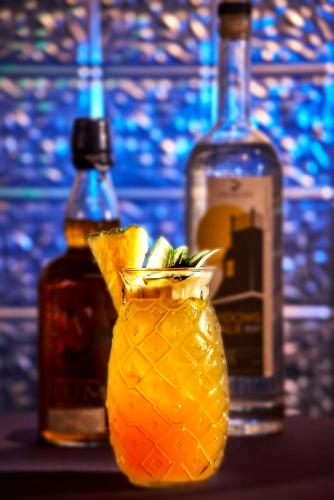 a bottle of alcohol and a vase with oranges in it at Revere Hotel Boston Common in Boston