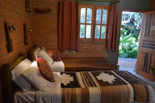 Tempat tidur dalam kamar di Hotel Rustico Cerro Del Valle