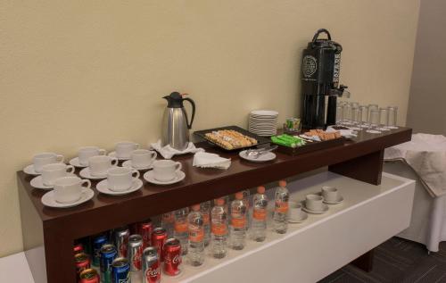 a table with cups and plates and drinks on it at Victoria Ejecutivo in Guadalajara