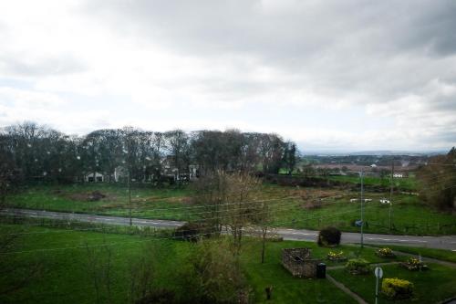 a view of a field with a road and trees at York House Durham in Durham