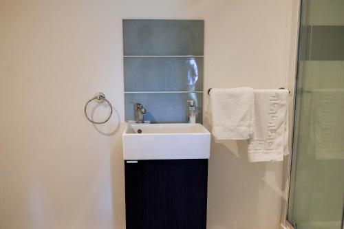 a bathroom with a sink and a shower and towels at York House Durham in Durham