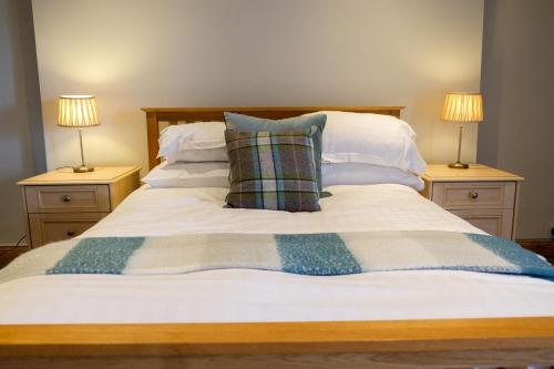 a bed with two lamps and two pillows on it at York House Durham in Durham
