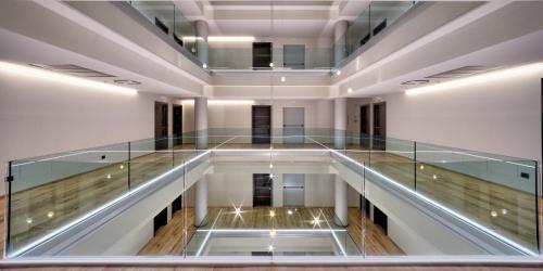 an empty glass corridor in a building with a glass floor at Hotel The Cube in Fidenza