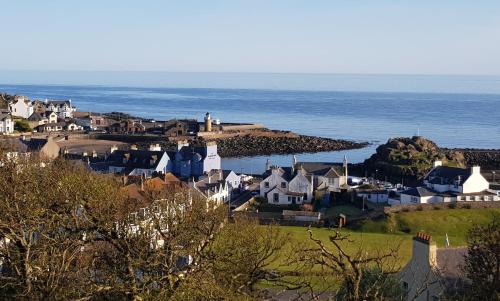 a small town with houses and the ocean at The Waterfront in Portpatrick