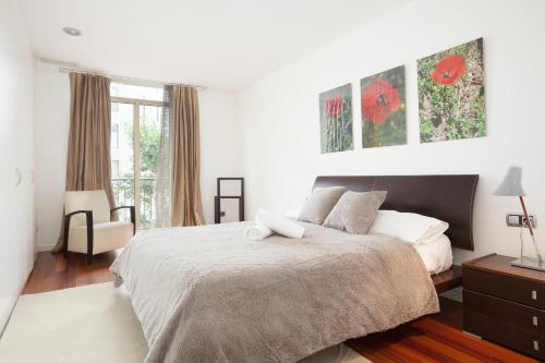 バルセロナにあるAkira Flats Plaza Catalunya Centric apartmentsの白いベッドルーム(ベッド1台、窓付)