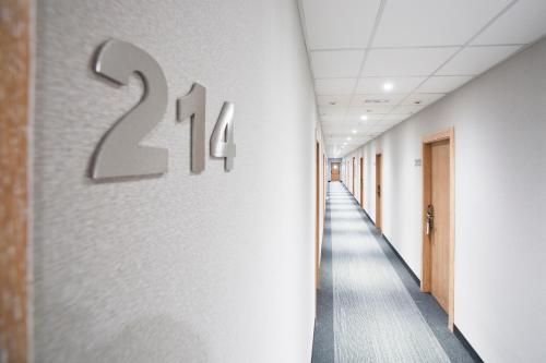 a hallway of an office building with a number on the wall at UVE Alcobendas in Alcobendas