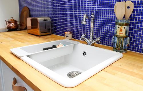 a white sink on a counter in a kitchen at Mini Flathotels in Pécs