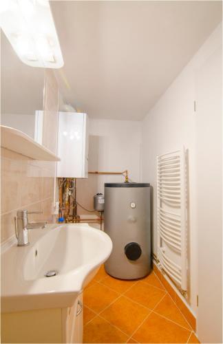 a bathroom with a sink and a trash can at Studio Southwest 1 with AirCon & FREE Parking in Ljubljana