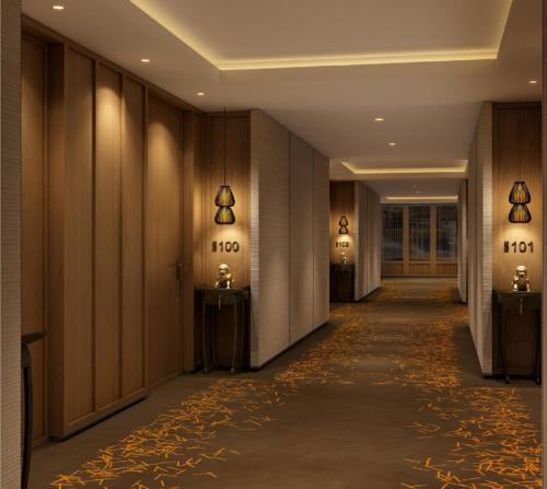 a large room with a large mirror and a walkway at Lotte Hotel Seoul Executive Tower in Seoul