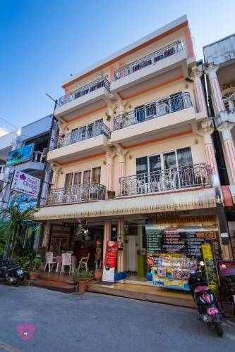 a large building with balconies on the side of it at Grand Orchid Inn Patong beach in Patong Beach