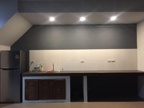 a kitchen with a counter top and a refrigerator at Anattaya Holiday Home in Ko Yao Noi