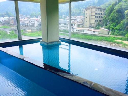a swimming pool with a view of a city at Seiryuso in Misasa