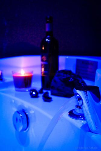a bottle of wine and a candle on a sink at Affittacamere B&B Carella in Palermo