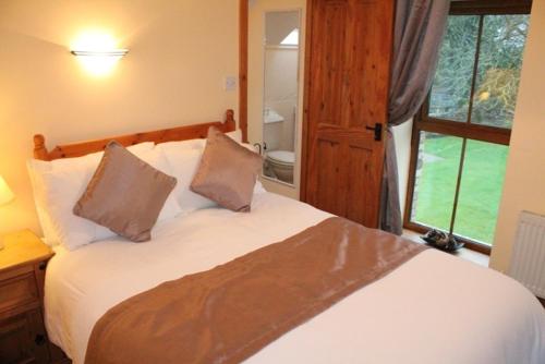a bedroom with a large white bed with two pillows at Moynure House Boutique B&B in Athlone