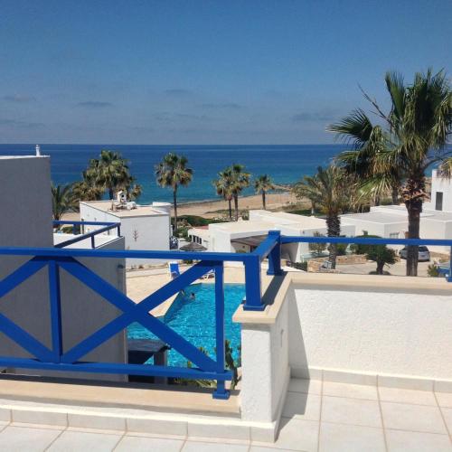 a view of the ocean from the balcony of a resort at Villa Margo by the Sea in Paphos City