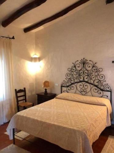 a bedroom with a bed with a white bedspread at Villa Margherita in Cannigione
