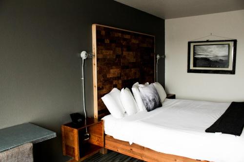 a hotel room with a bed with a head board at Adrift Hotel in Long Beach