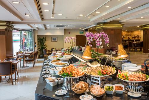 a buffet line of food in a restaurant at Hotel Grand Pacific in Singapore