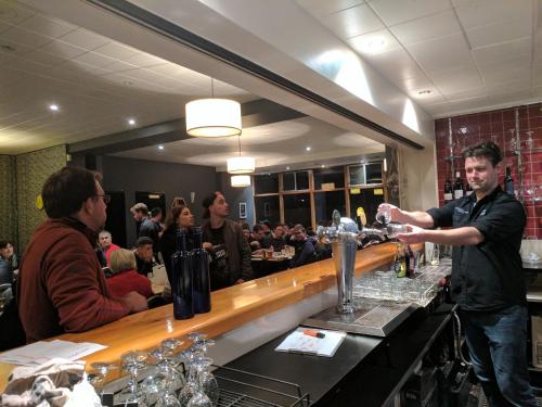 a man standing at a bar making a drink at Prince of Wales Hotel in Hobart