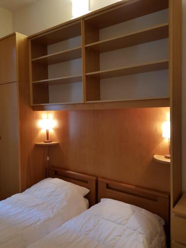 two beds in a room with shelves and lights at CA' di ROSE B&B VENICE in Venice
