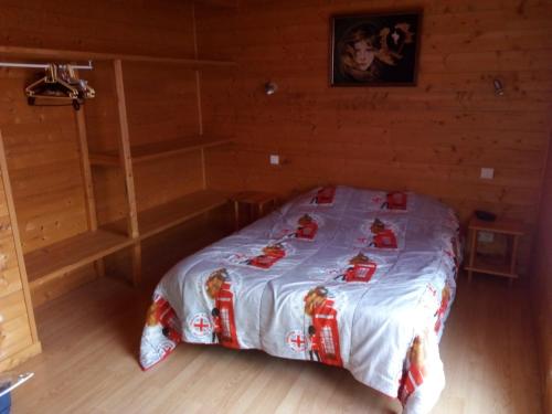 a bedroom with a bed in a wooden room at chalet 2007 in Le Boulay