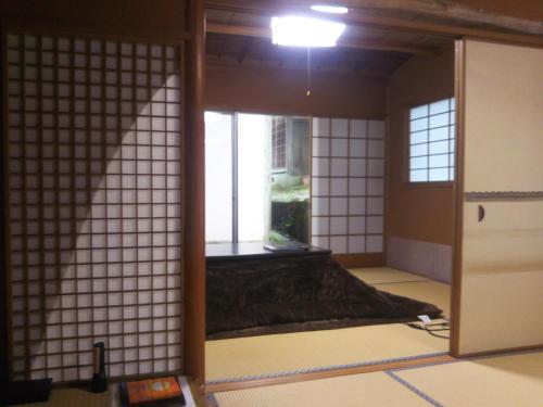 an open door in a room with a window at Koyasan Shukubo Sainanin in Koyasan
