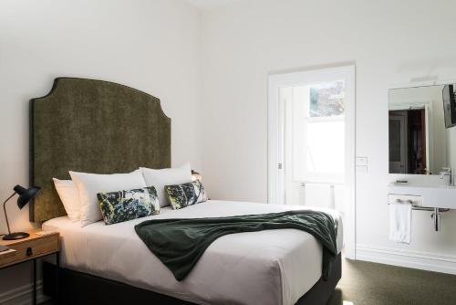 a bedroom with a large bed and a sink at The Florance in Launceston