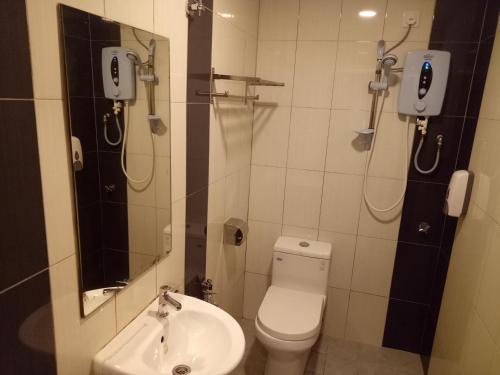 a bathroom with a toilet and a sink at Hotel Sri Bernam in Sabak Bernam